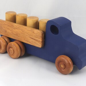 This handmade wooden Lorry truck is finished with navy blue acrylic paint and Amber Shellac. It is one of five towable trucks in this collection, available in many colors and unfinished. Custom Orders are welcome.
