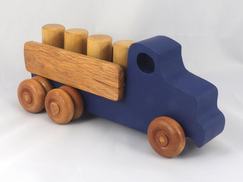 This handmade wooden Lorry truck is finished with navy blue acrylic paint and Amber Shellac. It is one of five towable trucks in this collection, available in many colors and unfinished. Custom Orders are welcome.
