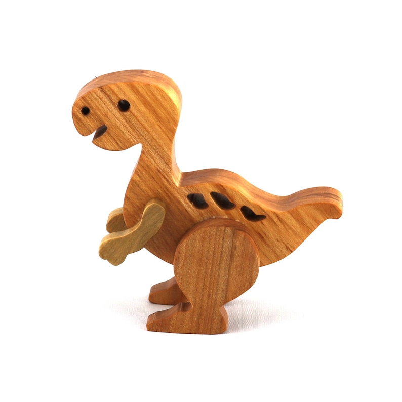 A wooden baby dinosaur figurine handmade and finished from select-grade hardwoods. It is an excellent toy for kids of any age. It is one of several dinosaurs in my collection.