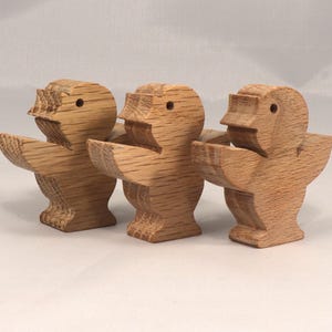 This is an unfinished wooden Singing Bird cutout from solid wood using traditional woodworking techniques. Sanded smooth and ready to paint, stain, or customize. Freestanding design for small hands, toddlers, young children, crafters, collectors, and display. I take custom orders for any animal, quantity, and mix — including large ornament orders. Mix and match, request a different size, or send a drawing or pattern. Handmade by Odin's Toy Factory in Tallahassee, Florida, USA.