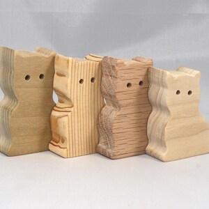 This is an unfinished wooden Sitting Cat cutout from solid wood using traditional woodworking techniques. Sanded smooth and ready to paint, stain, or customize. Freestanding design for small hands, toddlers, young children, crafters, collectors, and display. I take custom orders for any animal, quantity, and mix — including large ornament orders. Mix and match, request a different size, or send a drawing or pattern. Handmade by Odin's Toy Factory in Tallahassee, Florida, USA.