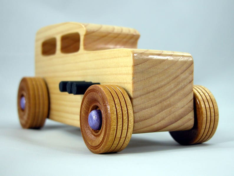 Handmade wooden toy car Hot Rod '32 Sedan finished with polyurethane, metallic purple and black trim, and nonmarring amber shellac wheels.
