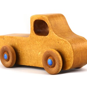 This handmade toy pickup truck from My Play Pal Collection is finished with amber shellac and metallic sapphire blue acrylic paint. It is just one of many unique wooden vehicles available.