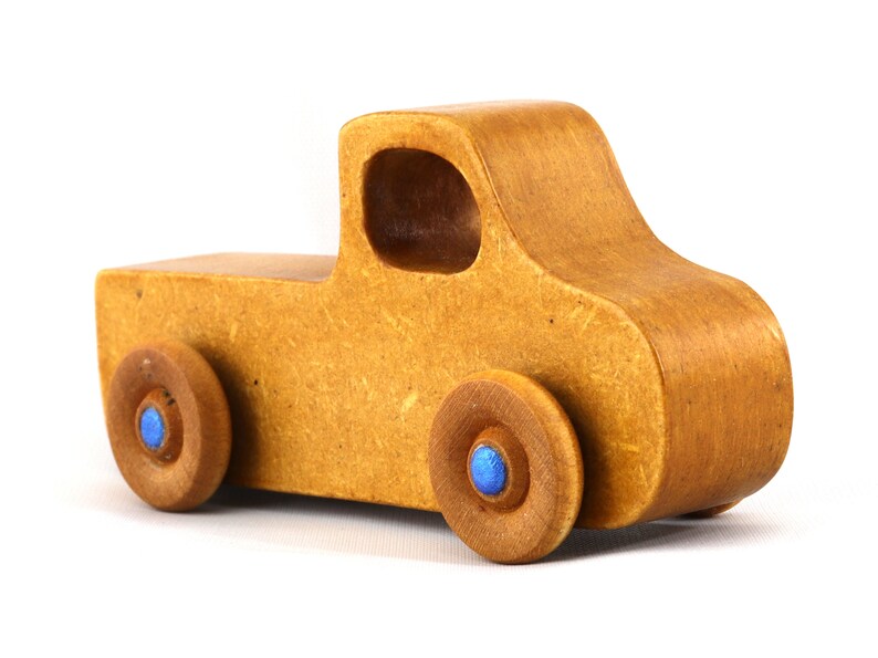 This handmade toy pickup truck from My Play Pal Collection is finished with amber shellac and metallic sapphire blue acrylic paint. It is just one of many unique wooden vehicles available.