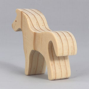 Handmade wooden toy horse cutout, perfect for children's playtime collection. Freestanding and stackable, ready to paint or customize. Endless possibilities for imaginative play, from farm scenes to towering animal creations.
