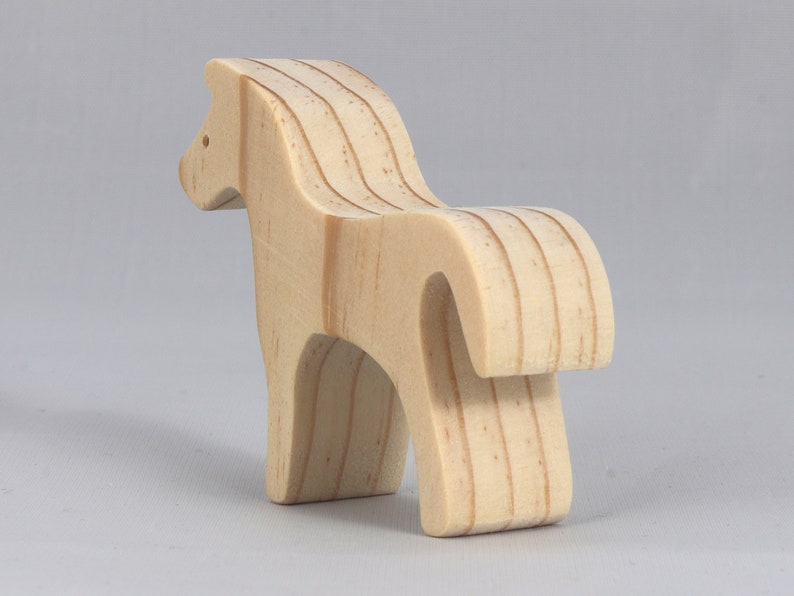Handmade wooden toy horse cutout, perfect for children's playtime collection. Freestanding and stackable, ready to paint or customize. Endless possibilities for imaginative play, from farm scenes to towering animal creations.