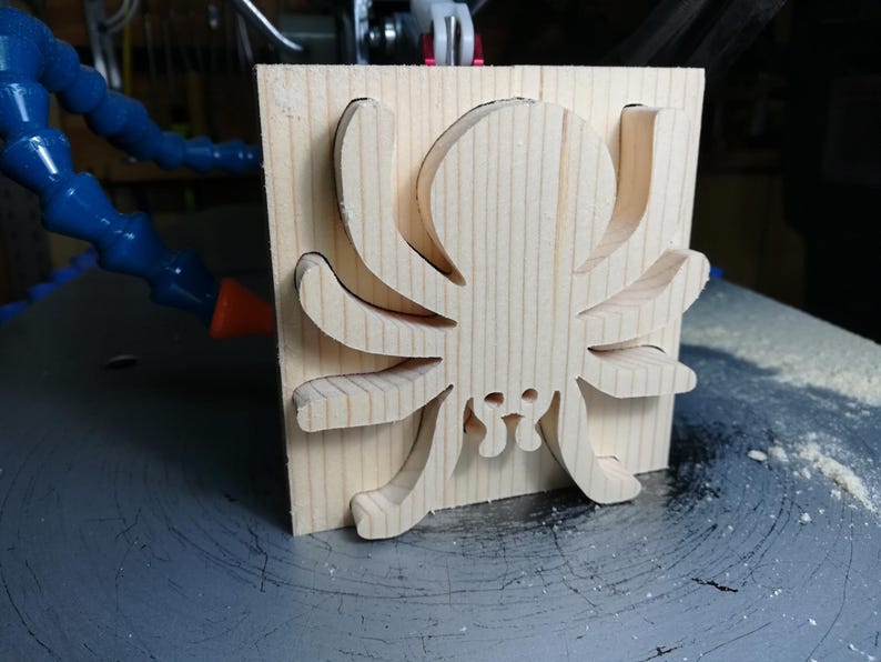Handmade unfinished wooden Halloween spider cutout from Odin's Toy Factory Snazzy Spooks Collection. Solid wood hand-cut spider, paintable, freestanding design. Approximate size 3.5 inches height by 3.5 inches width by 0.75 inches thick. Made in Tallahassee, Florida, USA.
