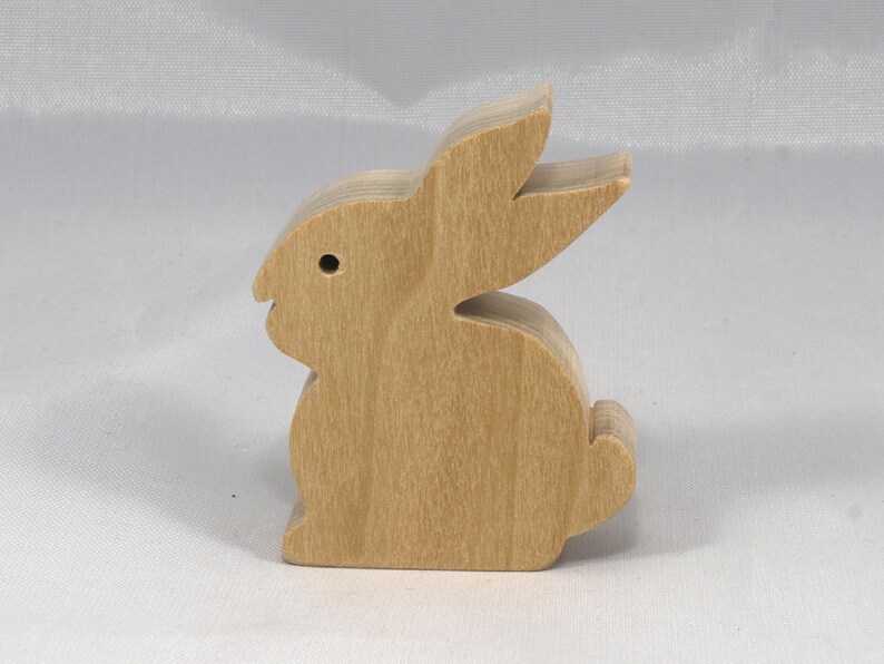 This is an unfinished wooden Rabbit cutout from solid wood using traditional woodworking techniques. Sanded smooth and ready to paint, stain, or customize. Freestanding design for small hands, toddlers, young children, crafters, collectors, and display. I take custom orders for any animal, quantity, and mix — including large ornament orders. Mix and match, request a different size, or send a drawing or pattern. Handmade by Odin's Toy Factory in Tallahassee, Florida, USA.