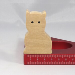 A handmade freestanding wooden toy cat cutout 1/2-3/4 inches thick is made from various kinds of wood sanded smooth and ready to paint. It is excellent for kids' crafts, pretend, or stacking toys. Other sizes are available with a custom order.