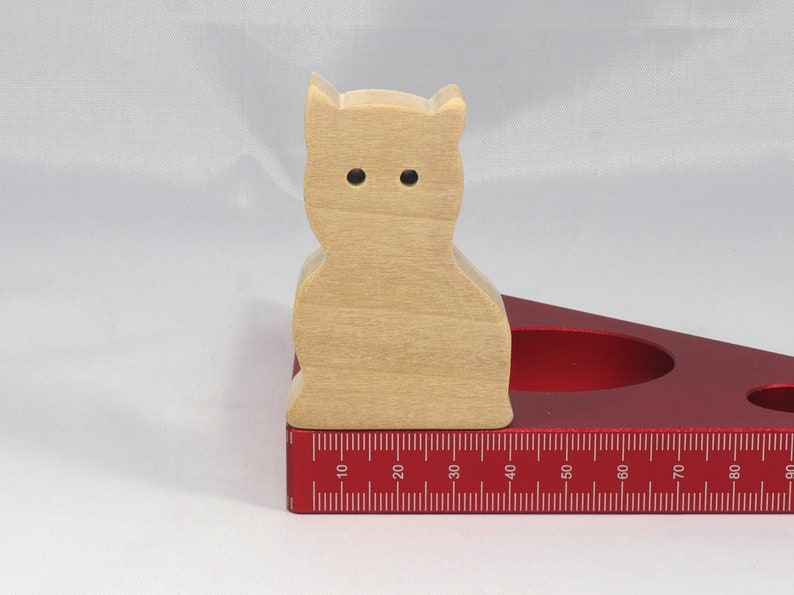 A handmade freestanding wooden toy cat cutout 1/2-3/4 inches thick is made from various kinds of wood sanded smooth and ready to paint. It is excellent for kids' crafts, pretend, or stacking toys. Other sizes are available with a custom order.