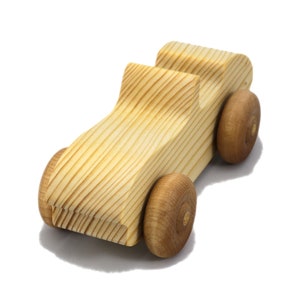 A small, handcrafted wooden toy convertible sports car, finished with a custom blend of oils and waxes, is the perfect gift for young children.