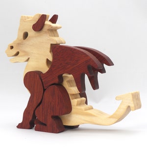 Hand-crafted baby dragon mythical fantasy animal figurine made from contrasting high-quality hardwoods and finished with non-toxic oils and waxes. Perfect for any dragon enthusiast.
