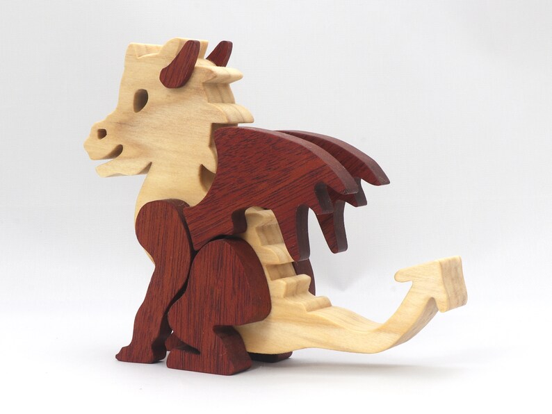 Hand-crafted baby dragon mythical fantasy animal figurine made from contrasting high-quality hardwoods and finished with non-toxic oils and waxes. Perfect for any dragon enthusiast.