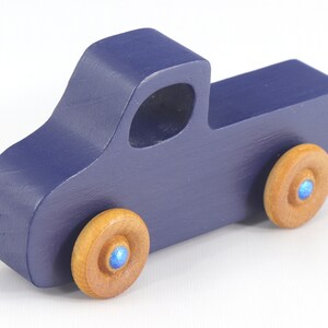 Handmade wooden toy pickup truck handmade and painted navy blue with amber shellac wheels and metallic sapphire blue trim. It's a little blue truck from my Play Pal Collection.