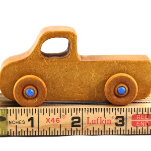 This handmade toy pickup truck from My Play Pal Collection is finished with amber shellac and metallic sapphire blue acrylic paint. It is just one of many unique wooden vehicles available.