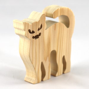 Handmade unfinished wooden Halloween cat cutout by Odin's Toy Factory. Freestanding cat figure cut from 3/4 inch thick wood and ready to paint. Approximate size 3.5 inches height by 3.5 inches width by 0.75 inches thick. Hand-cut solid wood Halloween decoration for crafts, toys, ornaments, and display. Custom orders available. Made in Tallahassee, Florida, USA.