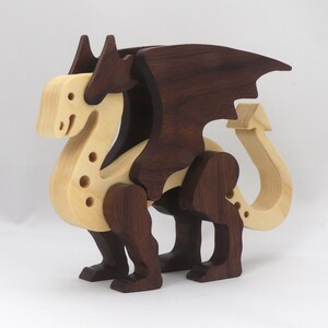 Handmade wooden dragon figurine made from contrasting hardwoods with a light natural wood body and head paired with rich dark reddish-brown wings, legs, and horns.