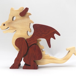 Hand-crafted baby dragon mythical fantasy animal figurine made from contrasting high-quality hardwoods and finished with non-toxic oils and waxes. Perfect for any dragon enthusiast.