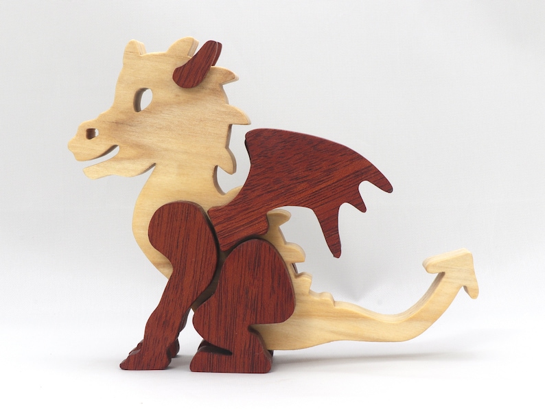 Hand-crafted baby dragon mythical fantasy animal figurine made from contrasting high-quality hardwoods and finished with non-toxic oils and waxes. Perfect for any dragon enthusiast.