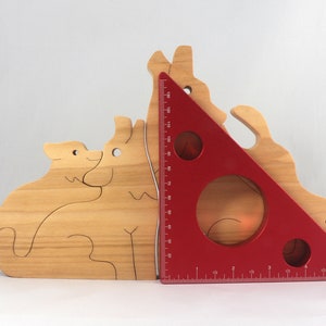 Wooden Wolf Family Stacking Puzzle is handmade from hardwood and finished with mineral oil, beeswax, and carnauba wax. Freestanding interlocking wolf family puzzle pieces shown assembled. Approximate size 10.5 inches long by 6.7 inches high by 3/4 inch thick. Handmade in Tallahassee, Florida, USA.