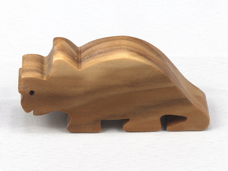 This small wooden triceratops dinosaur toy is crafted from high-quality hardwood and hand-finished. It is a delightful plaything for young children and appeals to many adults.