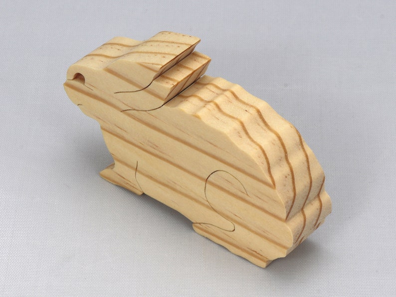 This is an unfinished wooden Rabbit cutout from solid wood using traditional woodworking techniques. Sanded smooth and ready to paint, stain, or customize. Freestanding design for small hands, toddlers, young children, crafters, collectors, and display. I take custom orders for any animal, quantity, and mix — including large ornament orders. Mix and match, request a different size, or send a drawing or pattern. Handmade by Odin's Toy Factory in Tallahassee, Florida, USA.