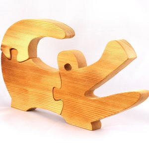 A 10-inch long wooden alligator puzzle for younger kids handmade and smoothly finished. This simple puzzle has three pieces, easy-to-grasp, interlocking, chunky, freestanding pieces. It is made to order.