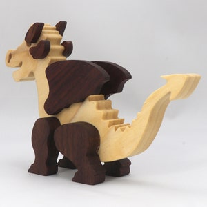 Wood Dragon Fantasy Animal Figurine is Handmade and finished with a renewable blend of mineral oil and waxes Applied hot for durabiliity and to enhance the beauty of the wood. There are ten dragons in this collection. A  link is in the description.