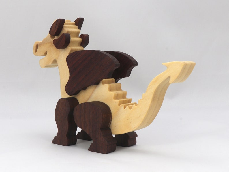 Wood Dragon Fantasy Animal Figurine is Handmade and finished with a renewable blend of mineral oil and waxes Applied hot for durabiliity and to enhance the beauty of the wood. There are ten dragons in this collection. A  link is in the description.