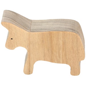 A handmade and unfinished wooden toy cow cutout is perfect for those who love to paint and customize their toys. It is freestanding and stackable, making it a versatile addition to any playroom or nursery. From My Itty Bitty Animal Collection.