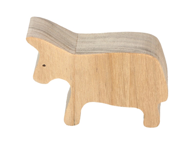A handmade and unfinished wooden toy cow cutout is perfect for those who love to paint and customize their toys. It is freestanding and stackable, making it a versatile addition to any playroom or nursery. From My Itty Bitty Animal Collection.