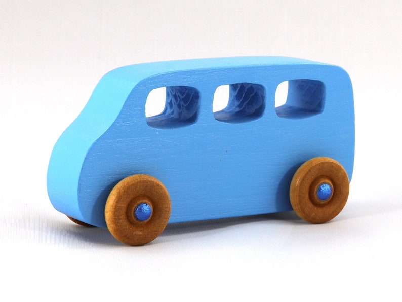 A Handmade wood toy mini van hand-painted baby blue with metallic sapphire blue trim and wheels finished with nonmarring amber shellac from my Play Pall Collection.