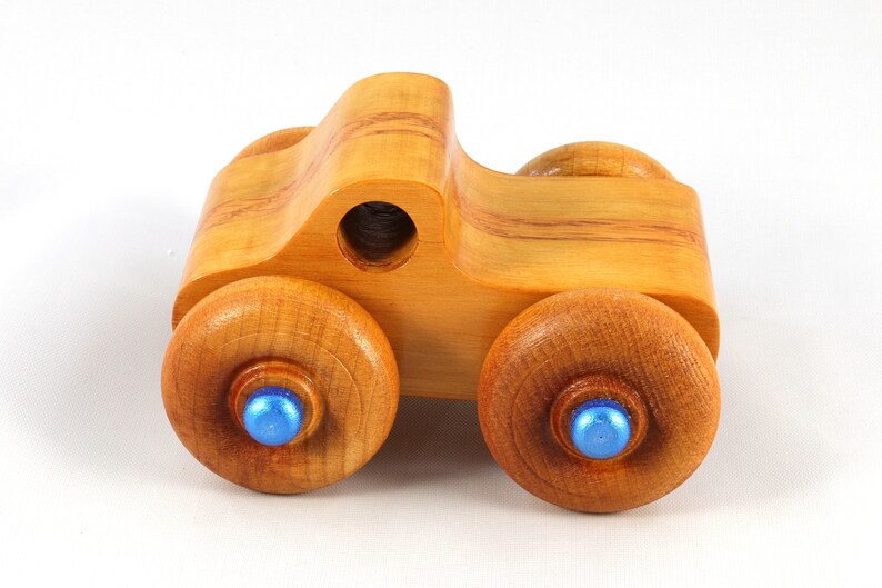 Wood Toy Monster Truck Handmade Form Hardwood and Finished With Amber Shellac With Metallic Saphire Blue Trim.