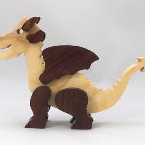 Wood Dragon Fantasy Animal Figurine is Handmade and finished with a renewable blend of mineral oil and waxes Applied hot for durabiliity and to enhance the beauty of the wood. There are ten dragons in this collection. A  link is in the description.