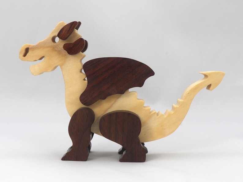 Wood Dragon Fantasy Animal Figurine is Handmade and finished with a renewable blend of mineral oil and waxes Applied hot for durabiliity and to enhance the beauty of the wood. There are ten dragons in this collection. A  link is in the description.