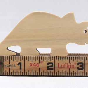 This is an unfinished wooden Wooden Toy Dinosaur Triceratops cutout from solid wood using traditional woodworking techniques. Sanded smooth and ready to paint, stain, or customize. Freestanding design for small hands, toddlers, young children, crafters, collectors, and display. I take custom orders for any animal, quantity, and mix — including large ornament orders. Mix and match, request a different size, or send a drawing or pattern. Handmade by Odin's Toy Factory in Tallahassee, Florida, USA.
