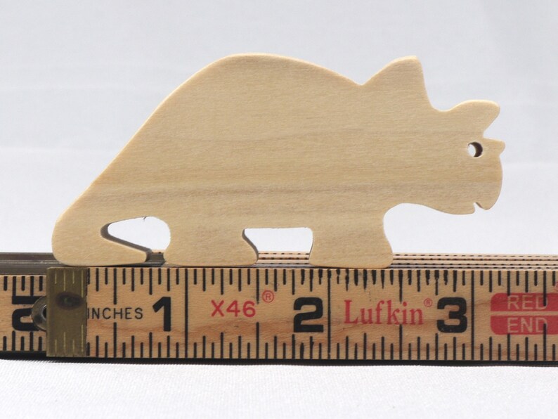 This is an unfinished wooden Wooden Toy Dinosaur Triceratops cutout from solid wood using traditional woodworking techniques. Sanded smooth and ready to paint, stain, or customize. Freestanding design for small hands, toddlers, young children, crafters, collectors, and display. I take custom orders for any animal, quantity, and mix — including large ornament orders. Mix and match, request a different size, or send a drawing or pattern. Handmade by Odin's Toy Factory in Tallahassee, Florida, USA.