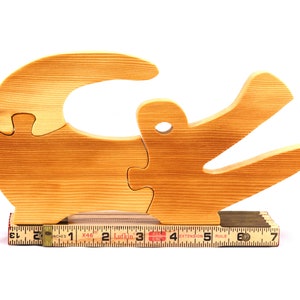 A 10-inch long wooden alligator puzzle for younger kids handmade and smoothly finished. This simple puzzle has three pieces, easy-to-grasp, interlocking, chunky, freestanding pieces. It is made to order.