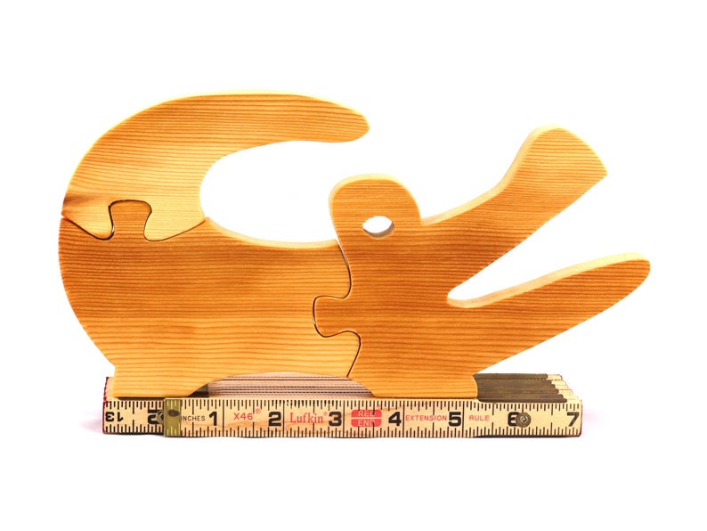 A 10-inch long wooden alligator puzzle for younger kids handmade and smoothly finished. This simple puzzle has three pieces, easy-to-grasp, interlocking, chunky, freestanding pieces. It is made to order.