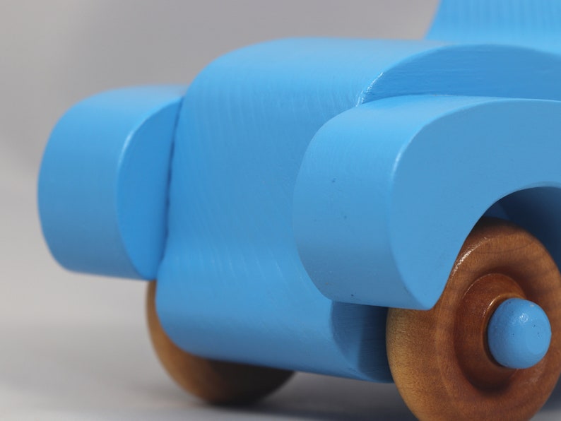 Handmade painted wooden toy car, baby blue convertible with fat fendered roadster design. Non-marring wheels finished with amber shellac.
