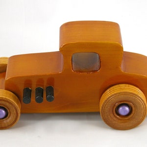 Handmade wooden toy car '27 T-Coupe, finished with amber shellac, metallic purple, and black acrylic paint. Made to order.