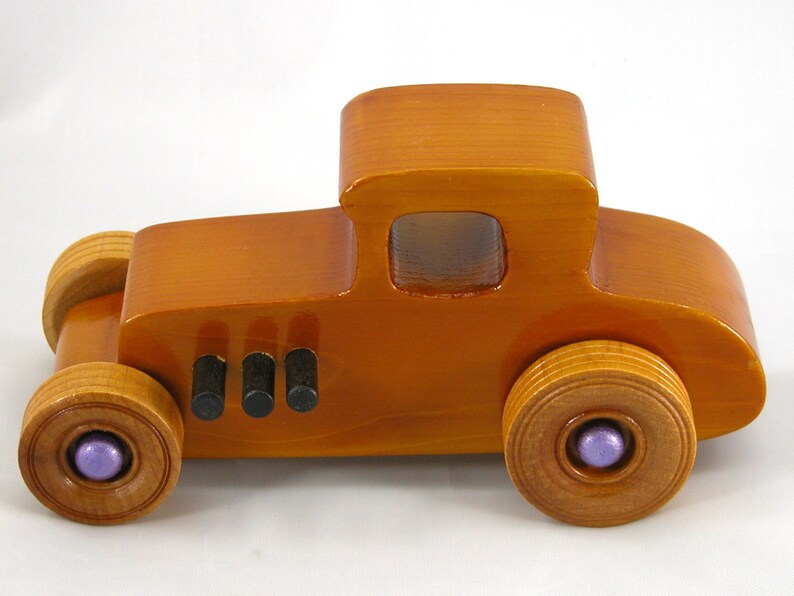 Handmade wooden toy car '27 T-Coupe, finished with amber shellac, metallic purple, and black acrylic paint. Made to order.