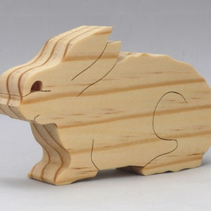 This is an unfinished wooden Rabbit cutout from solid wood using traditional woodworking techniques. Sanded smooth and ready to paint, stain, or customize. Freestanding design for small hands, toddlers, young children, crafters, collectors, and display. I take custom orders for any animal, quantity, and mix — including large ornament orders. Mix and match, request a different size, or send a drawing or pattern. Handmade by Odin's Toy Factory in Tallahassee, Florida, USA.