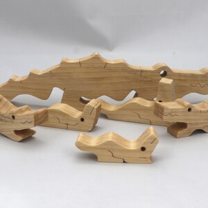 Handmade Wood Alligator Family Stacking Puzzle Mom and five baby (hatchling) alligators. This freestanding puzzle is hand-finished with a custom blend of mineral oil and waxes for a beautiful, smooth, and durable finish.