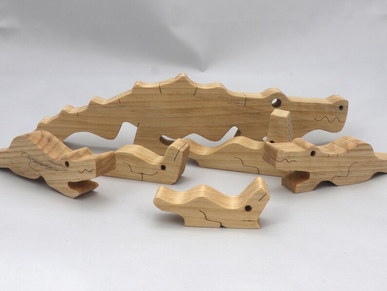 Handmade Wood Alligator Family Stacking Puzzle Mom and five baby (hatchling) alligators. This freestanding puzzle is hand-finished with a custom blend of mineral oil and waxes for a beautiful, smooth, and durable finish.