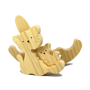 Handmade Wood Puzzle featuring Moma Cat and Baby Kitten in a Rocker, a simple three-part design crafted with traditional woodworking tools. Smoothly sanded and finished with a blend of mineral oil and beeswax for a lustrous touch.