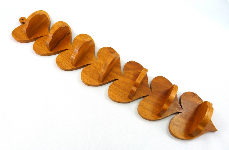 Handmade heart-shaped shelf crafted from reclaimed oak hardwood and finished with polyurethane. Perfect for displaying small items and adding rustic charm to home decor.