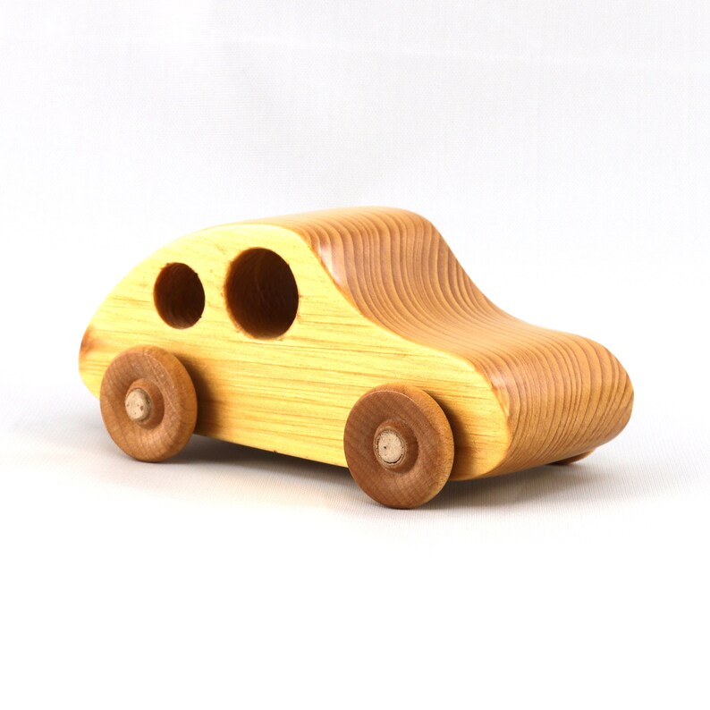 A handmade wooden toy car from the My Play Pal collection finished with durable satin polyurethane and amber shellac. It is made to order.
