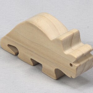 This is an unfinished wooden Wooden Toy Dinosaur Triceratops cutout from solid wood using traditional woodworking techniques. Sanded smooth and ready to paint, stain, or customize. Freestanding design for small hands, toddlers, young children, crafters, collectors, and display. I take custom orders for any animal, quantity, and mix — including large ornament orders. Mix and match, request a different size, or send a drawing or pattern. Handmade by Odin's Toy Factory in Tallahassee, Florida, USA.