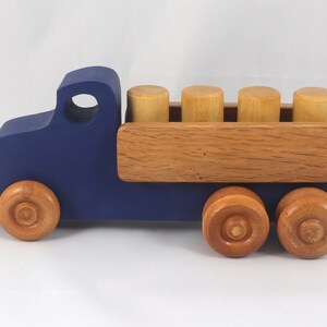 This handmade wooden Lorry truck is finished with navy blue acrylic paint and Amber Shellac. It is one of five towable trucks in this collection, available in many colors and unfinished. Custom Orders are welcome.